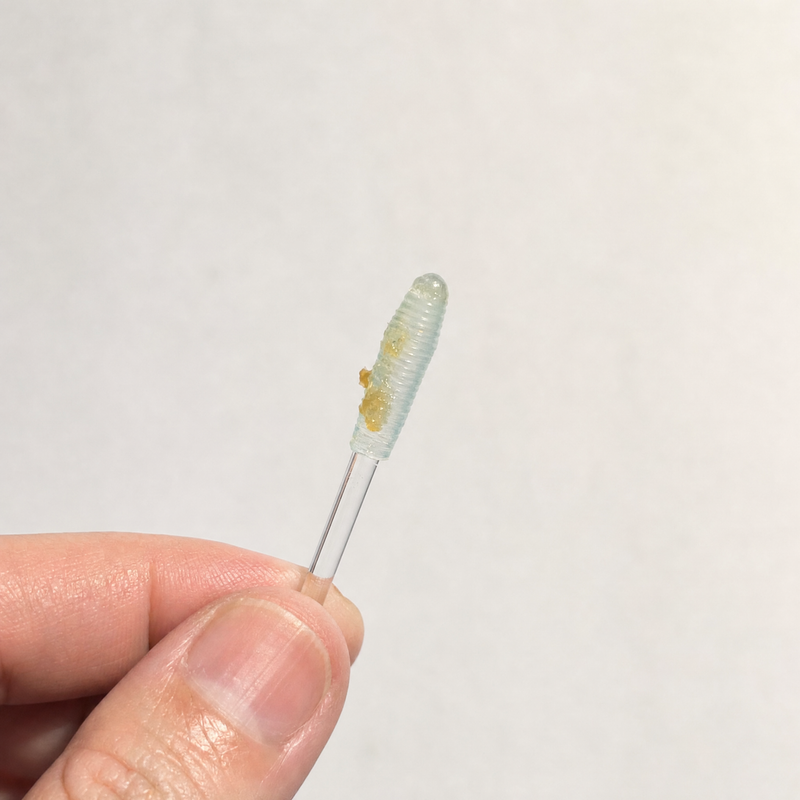 The Elariq stick tip after use with wax visible on the adhesive